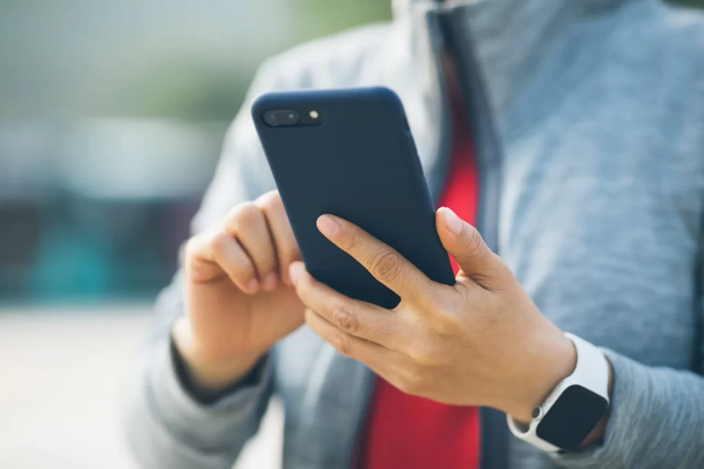 asian woman using smartphone at city utc