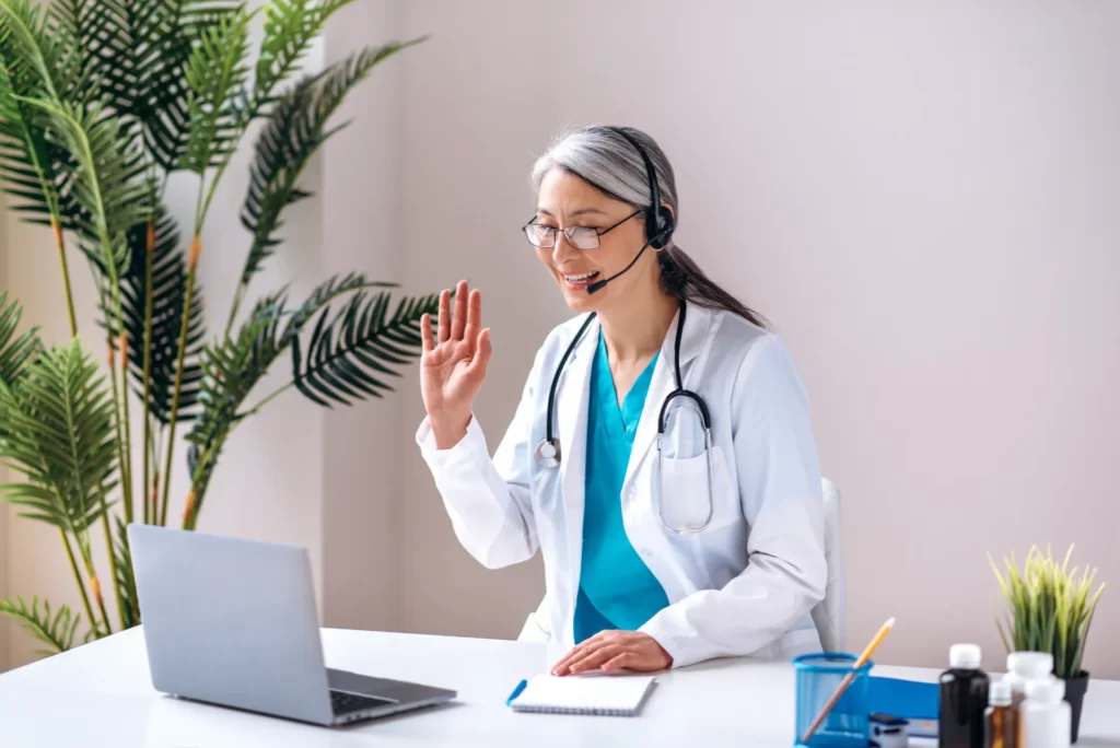 doctor waving during telemedicine appointment in o utc ()